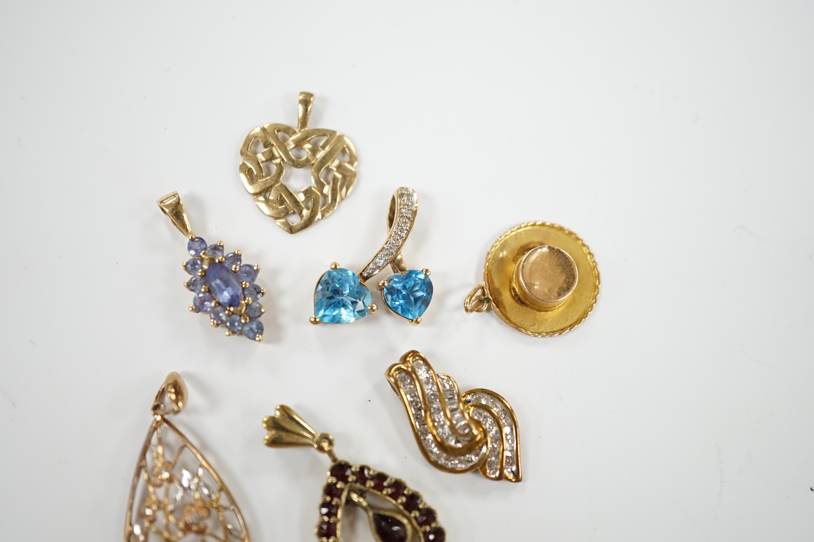 Seven assorted modern mainly 9ct and gem set small pendants, including diamond chip cluster, gross weight 10.4 grams.